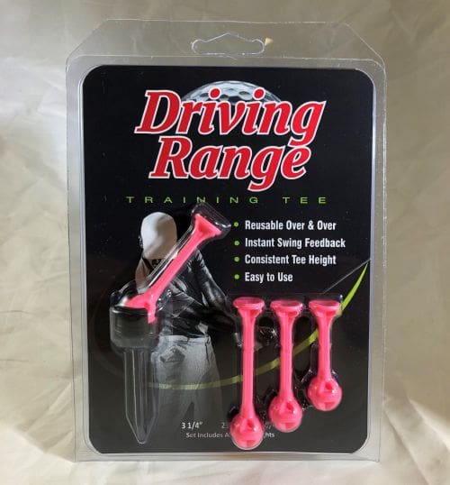 A pink driving range training tee in its packaging.