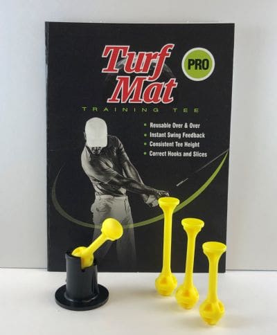 A yellow book with some black and white golf balls