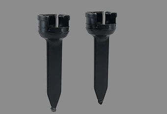 A pair of black plastic forks with one pointing to the side.
