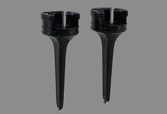 A pair of black plastic stands with two different size ones.