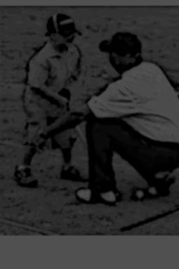 A black and white photo of two men playing baseball.