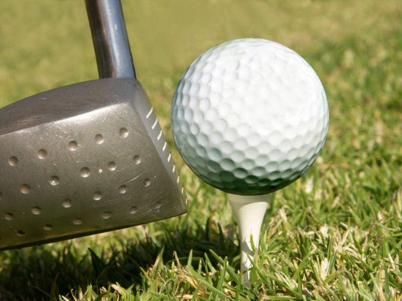 A close up of a golf ball on the tee