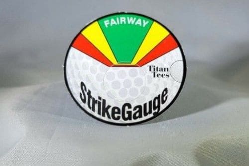A golf ball with the words " strike gauge " on it.